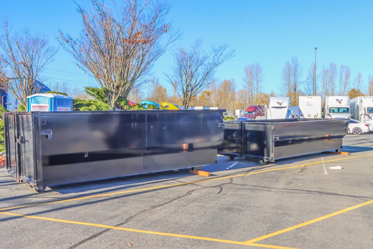 Professional dumpster rental service with roll-off container on residential driveway in Knoxville